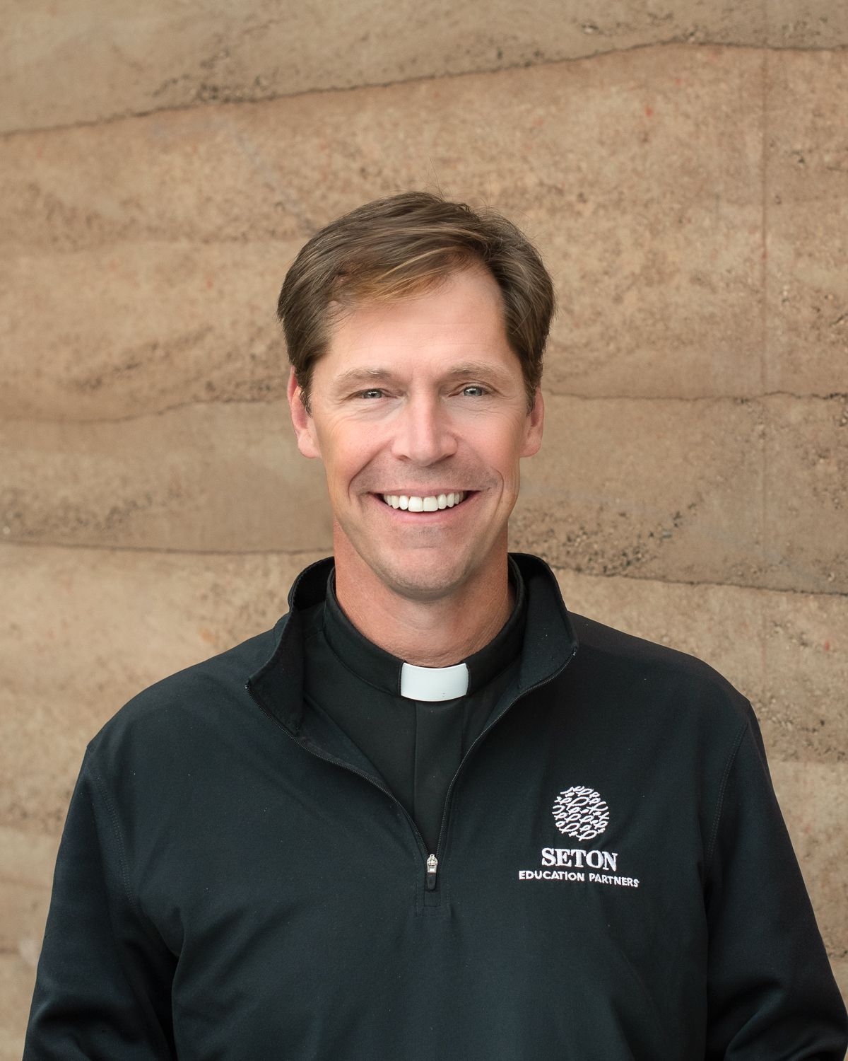 Headshot of a man in his work sweater at Lone Rock Retreat in Bailey, CO