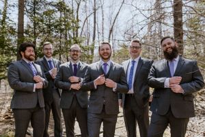 Groom and groomsmen tidy their suits for a photo in Shubie Park, Dartmouth Nova Scotia