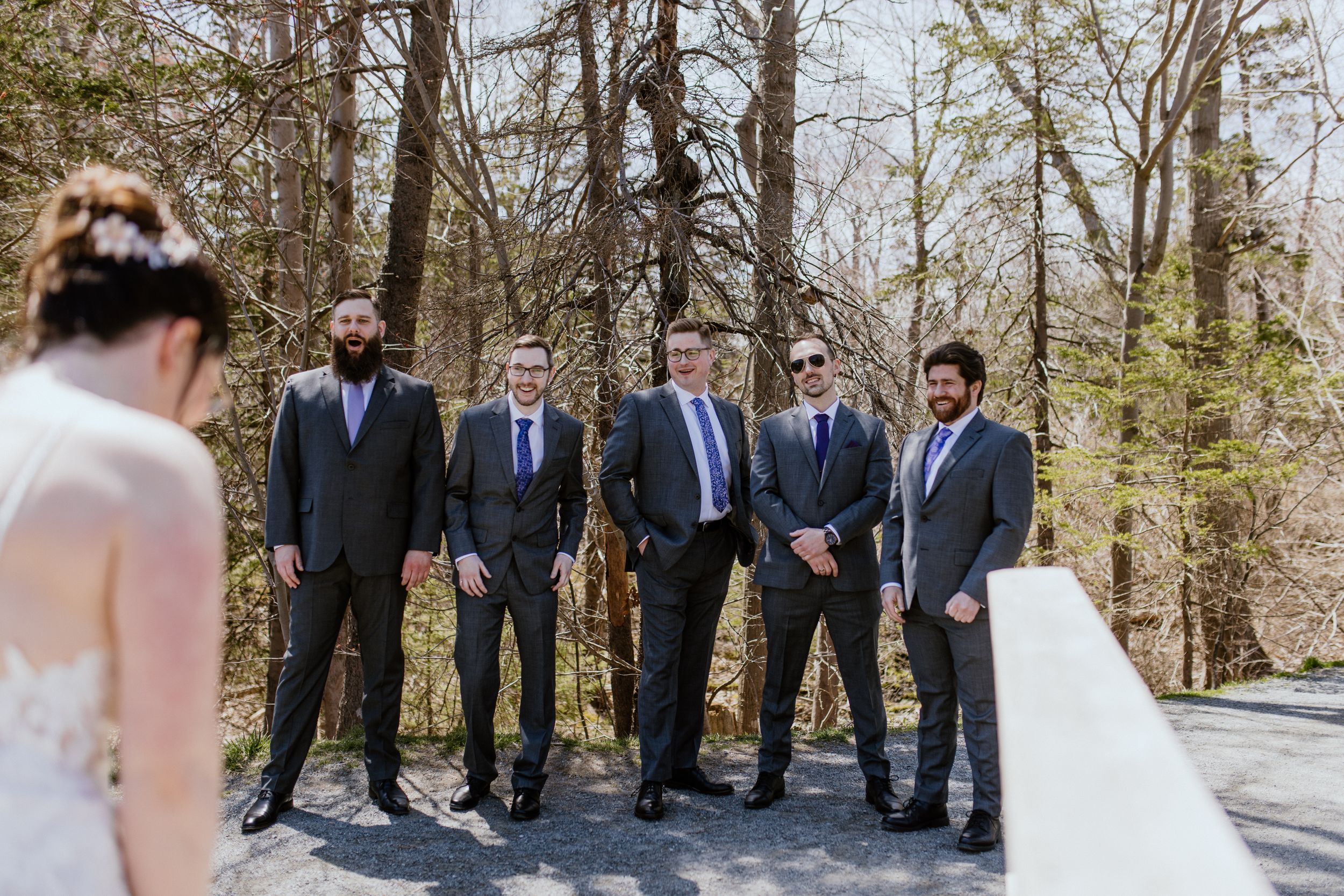 Bride does first look with groomsmen at Shubie Park in Dartmouth, Nova Scotia