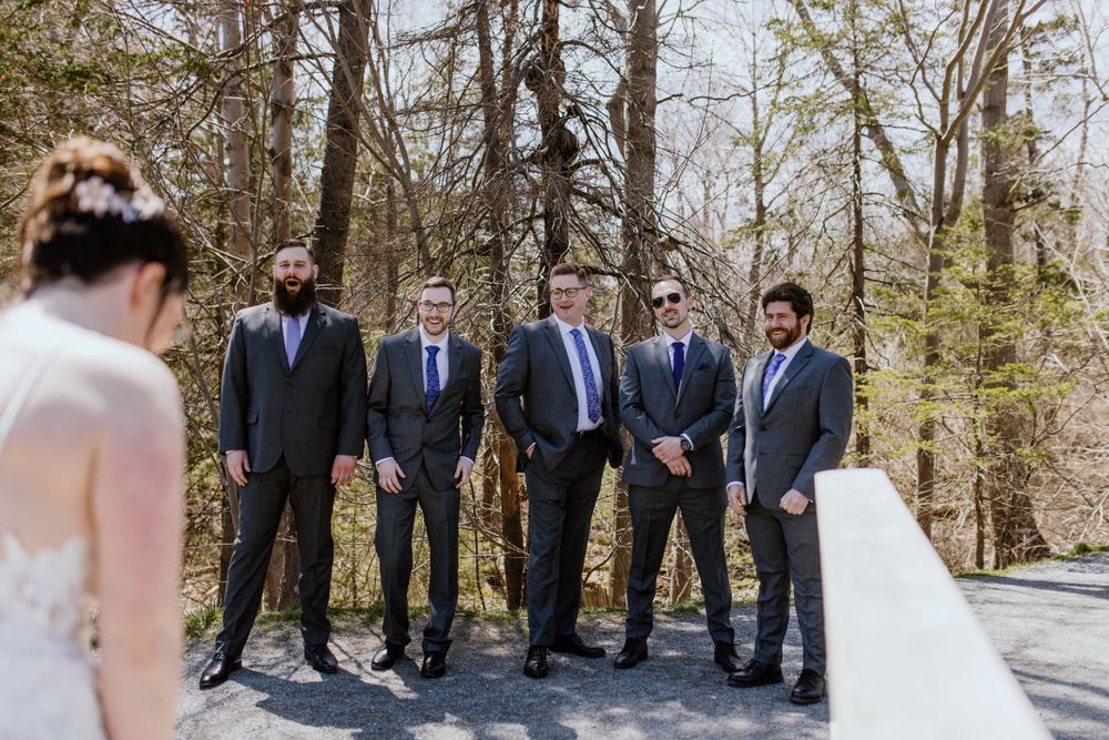 Bride does first look with groomsmen at Shubie Park in Dartmouth, Nova Scotia