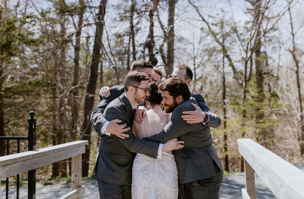 Bride does first look with groomsmen at Shubie Park in Dartmouth, Nova Scotia