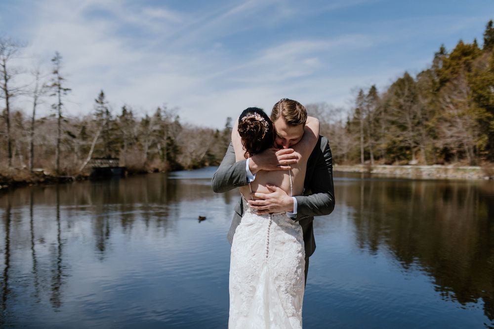 First look with bride and groom by the water in Shubie Park, Dartmouth, Nova Scotia