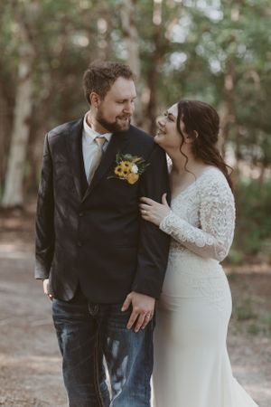 Romantic outdoor wedding portrait capturing a tender moment between newlyweds.