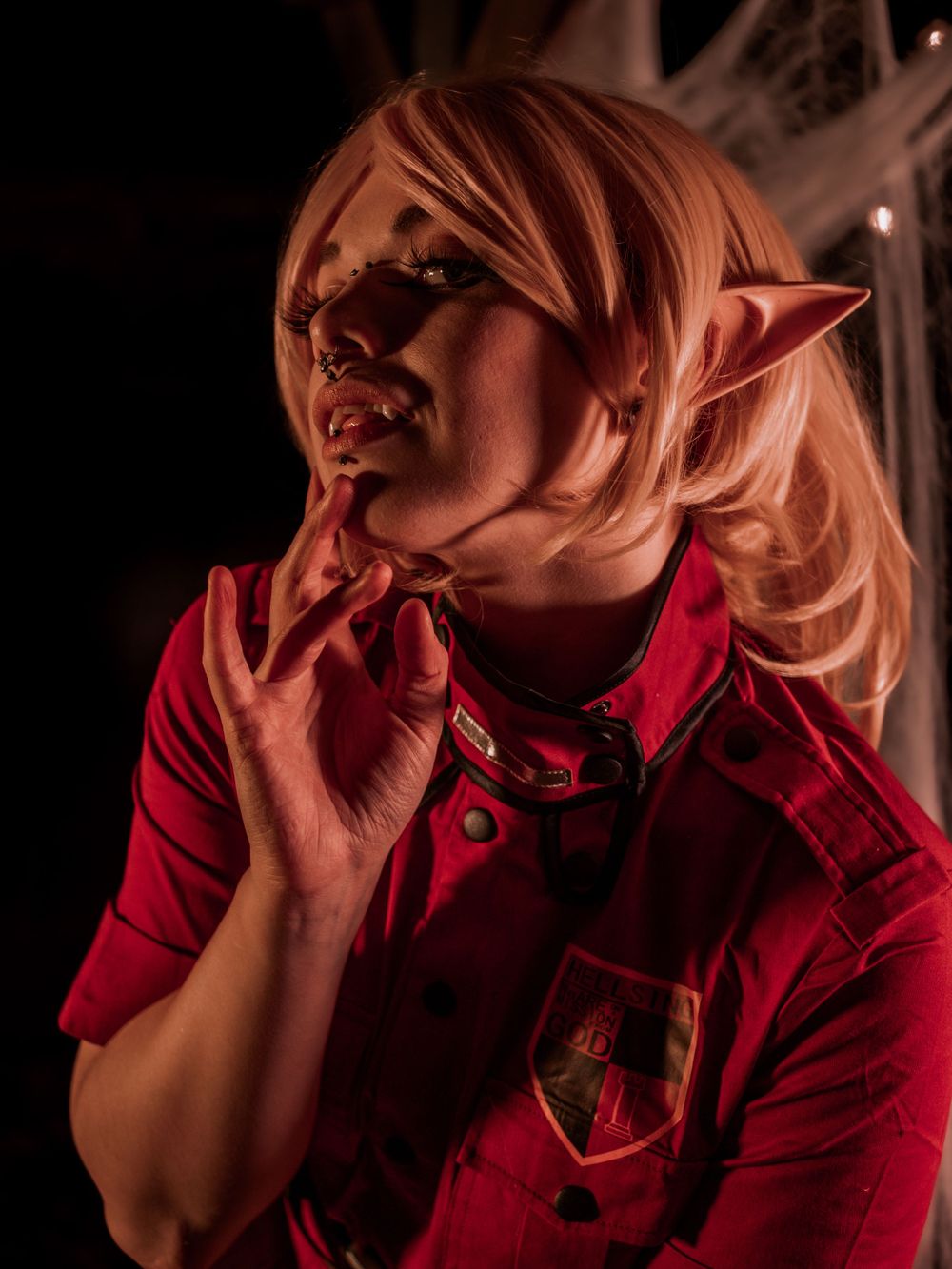 Dramatic side profile of cosplay character with fantasy ear prosthetics.