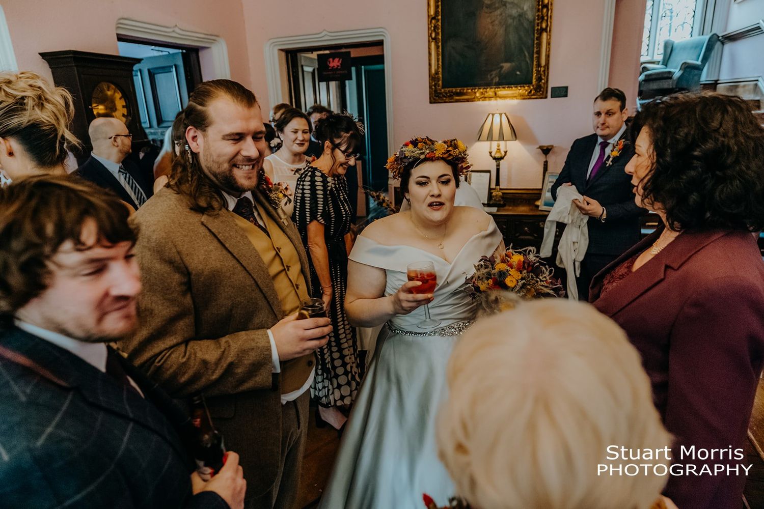 bride and groom smiling and chatting with guests after the ceremony. Ruthin castle wedding photographer.