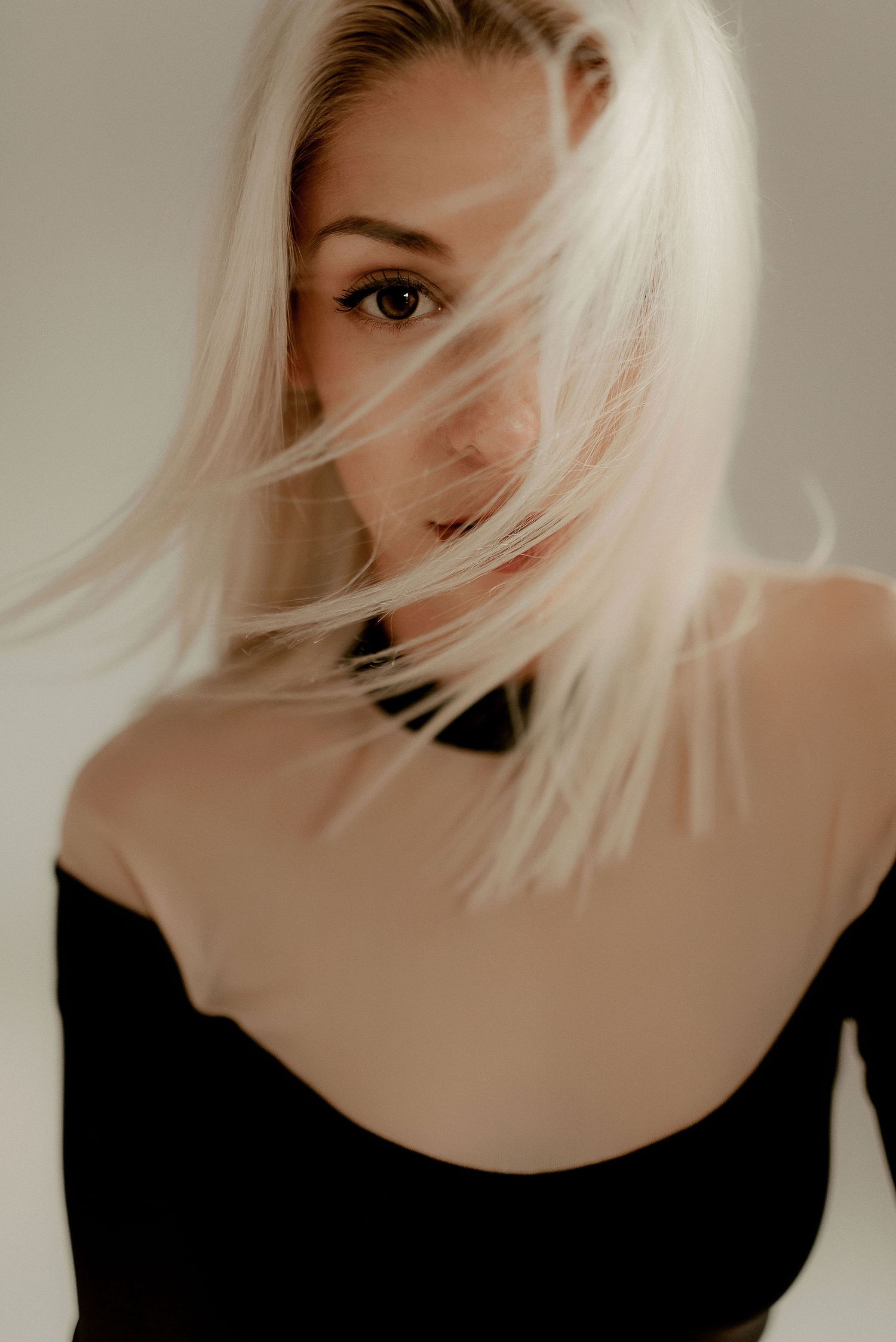 Artistic portrait series showing platinum blonde hair flowing against neutral background.
