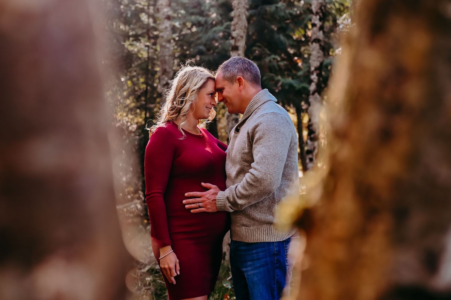 Couple hold each other in the woods