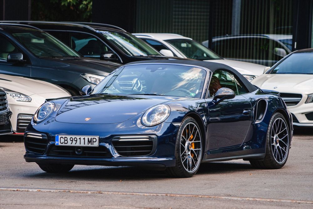 Dark blue Porsche 911 Turbo S displaying its aggressive front-end design.