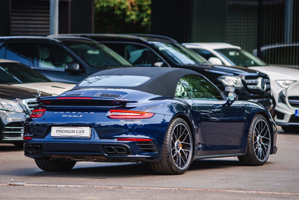 Porsche 911 Turbo in midnight blue showcasing its muscular rear quarter panel design.