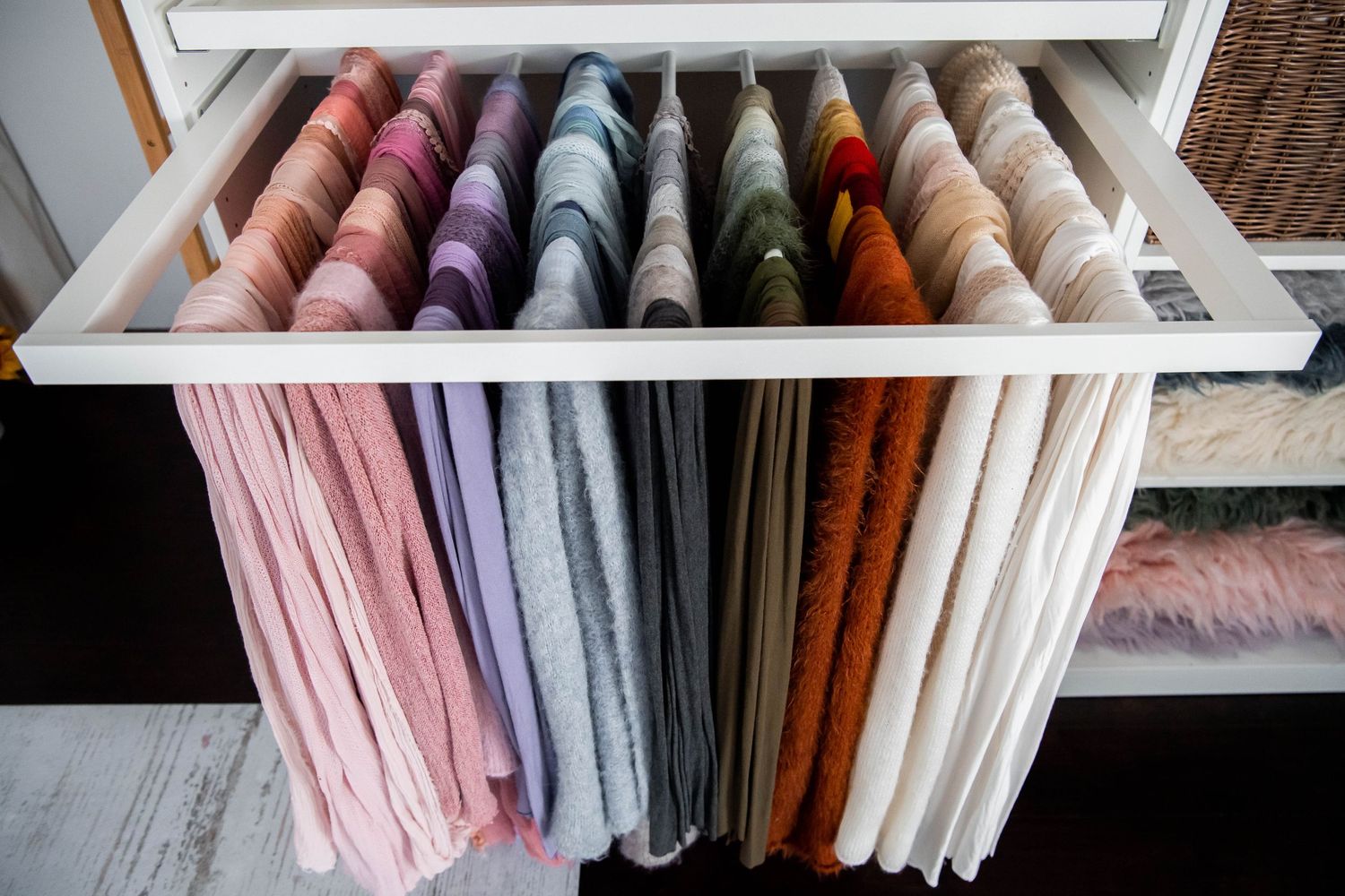 Colorful collection of fabric samples hanging neatly in pastel and jewel tones.