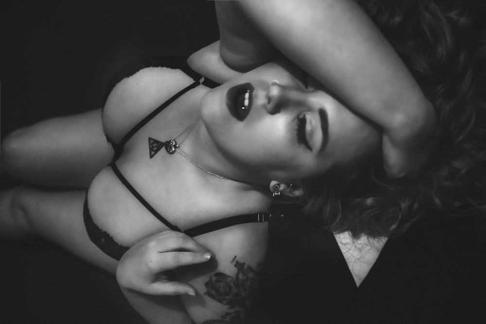 Dramatic black and white boudoir portraits with expressive poses.