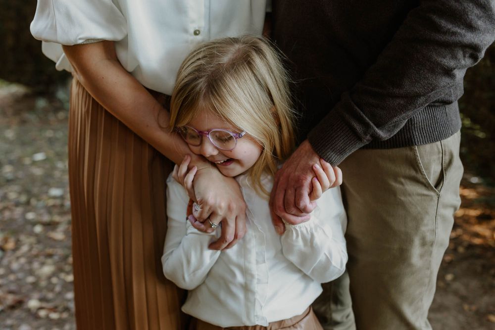 A tender moment of family connection captured outdoors in autumn.