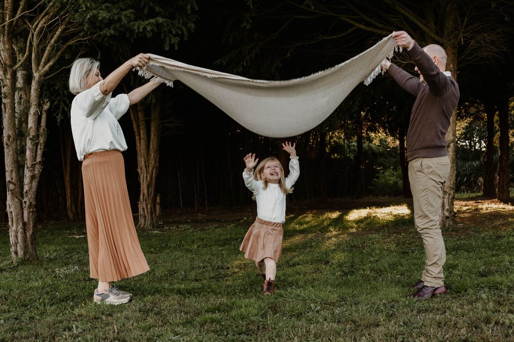 Playing with a white sheet in a backyard game during golden hour.