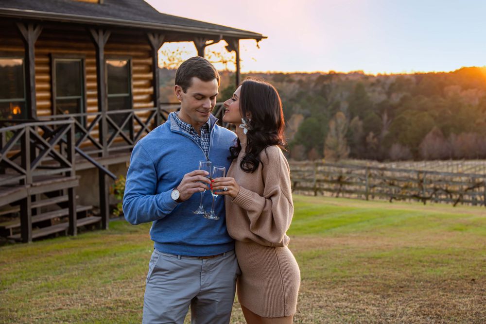 newly engaged happy couple sunset proposal drinking wine
