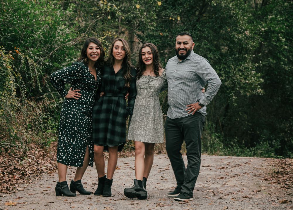 mom dad daughters taking a walk family of four