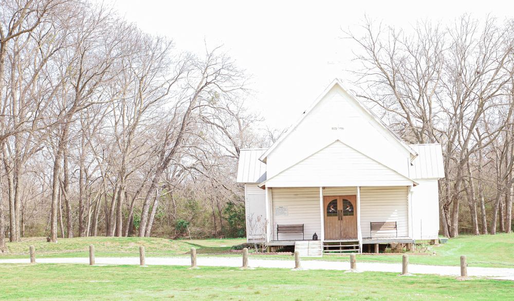 old country church white building in grass