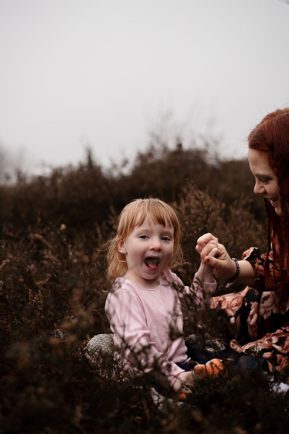 Candid moment of joy and laughter while playing outdoors in nature.