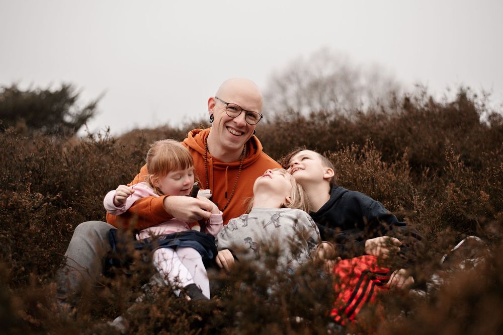 Heartwarming outdoor family moment in rustic autumn setting.
