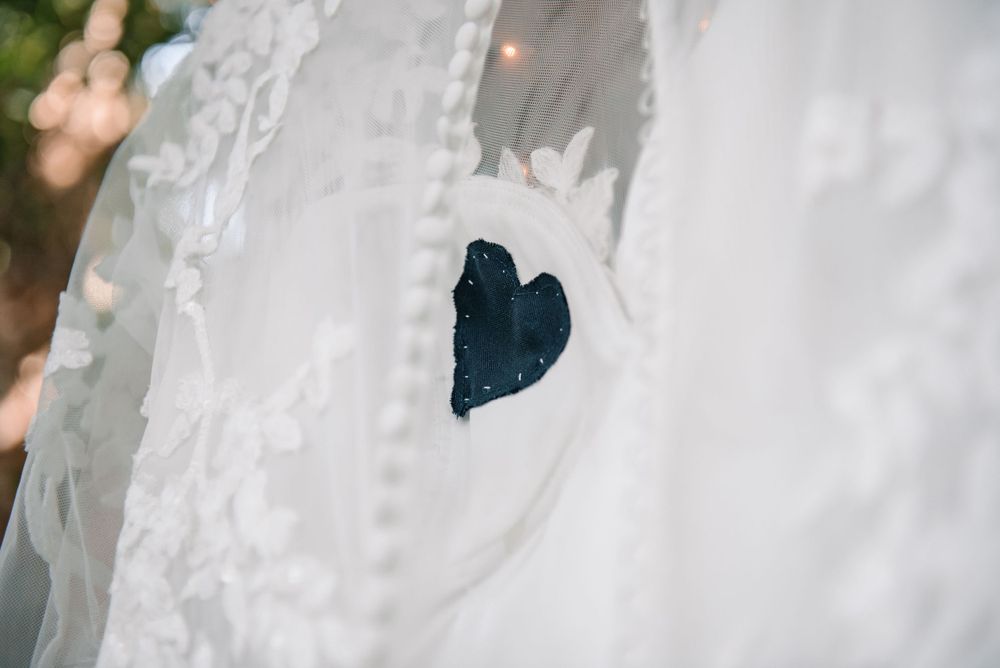 Close-up detail of delicate white lace on a wedding gown.
