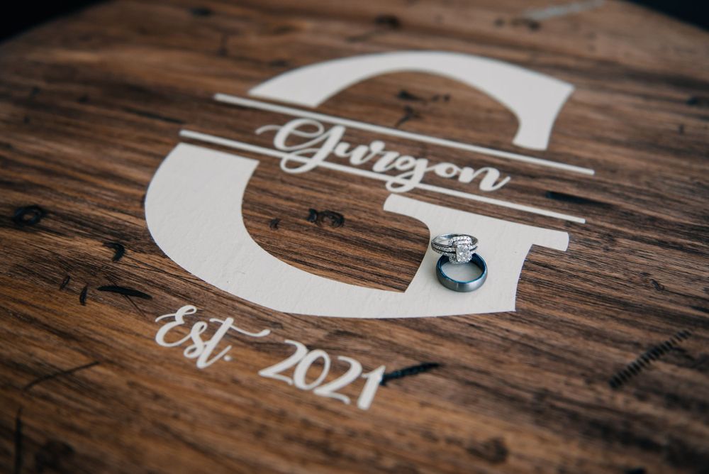 Wedding date 'Est 2021' typography detail on rustic wooden background.