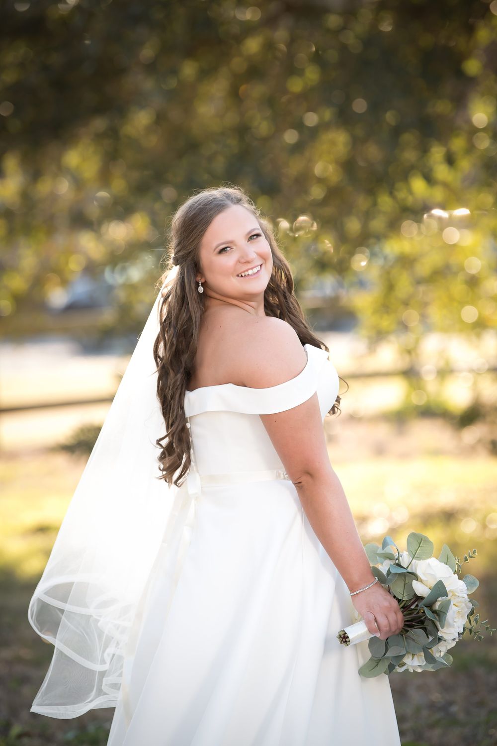 Outdoor bridal photography session with warm golden hour lighting and natural bokeh effects.