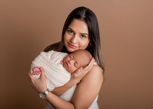 A series of intimate maternity portraits showing a woman in white against a warm brown background.