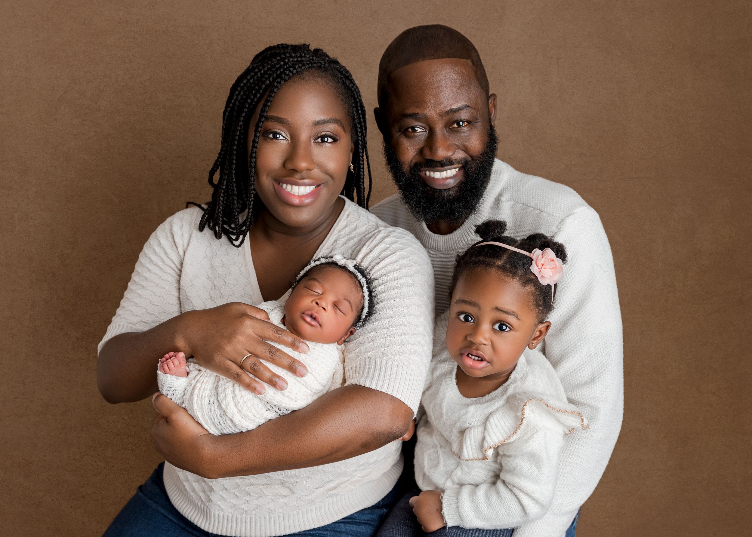 A series of warm brown-toned family portrait photos showing loving embraces and smiles in matching cream-colored outfits.