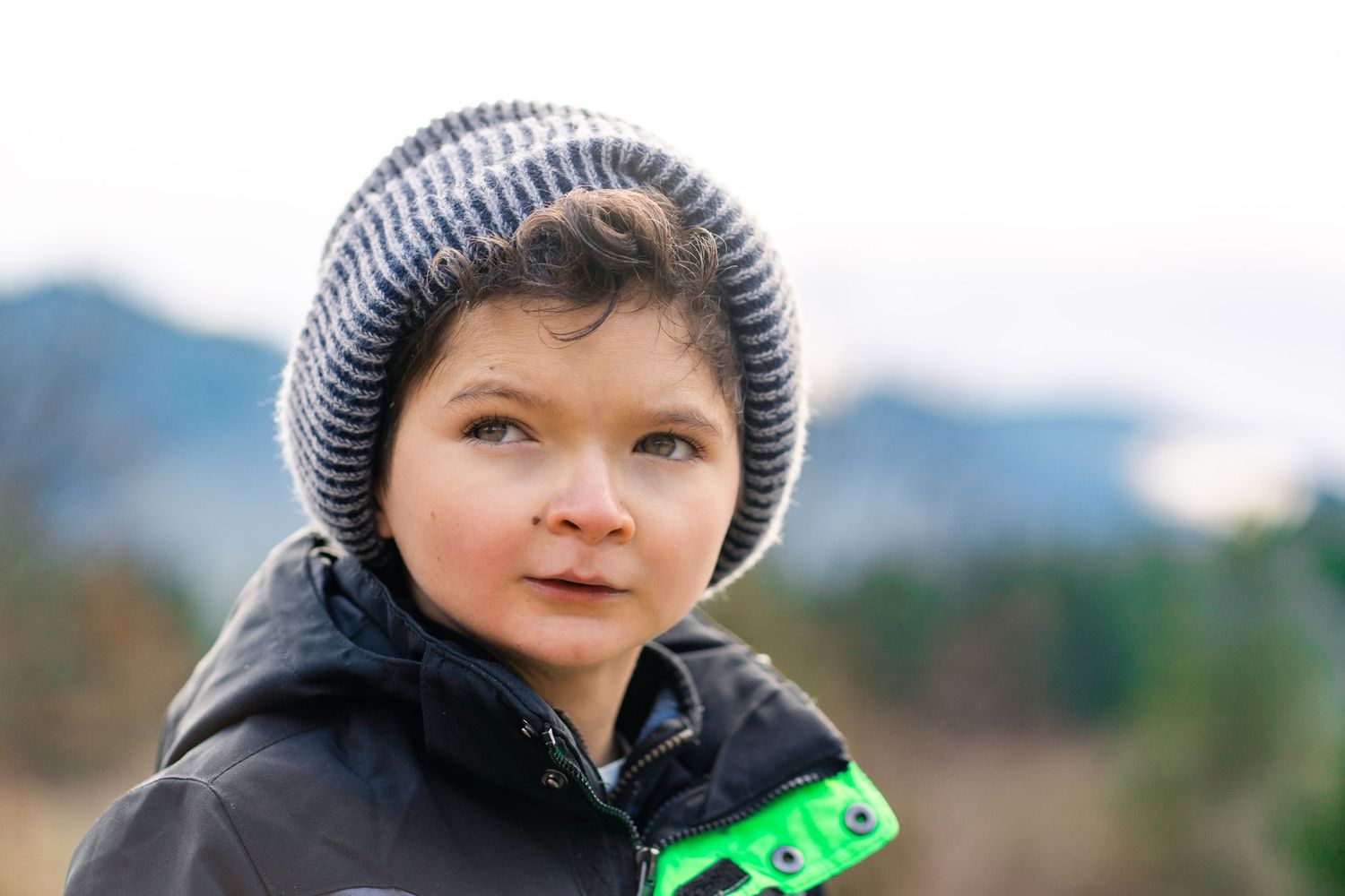 portrait of a boy with the mountains in the background