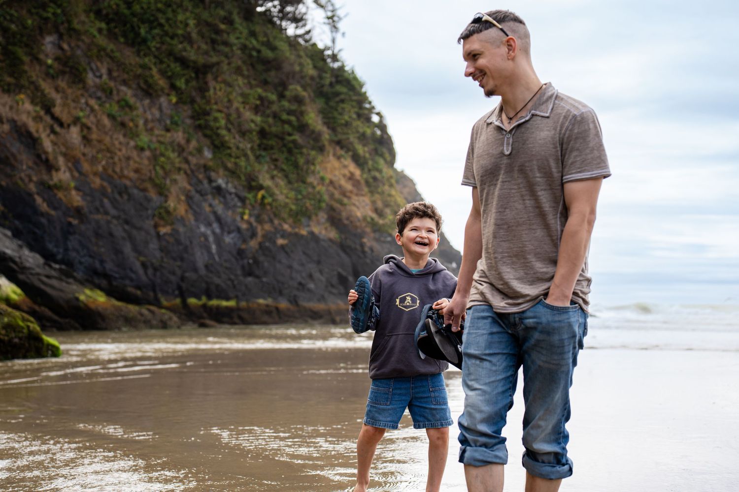 father and son playing at the beach