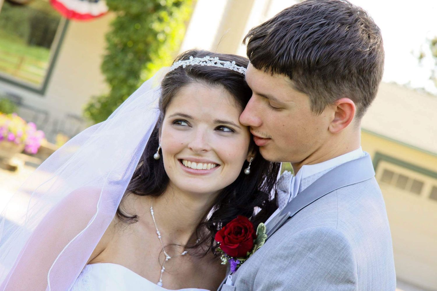 wedding couple with veil and red flower