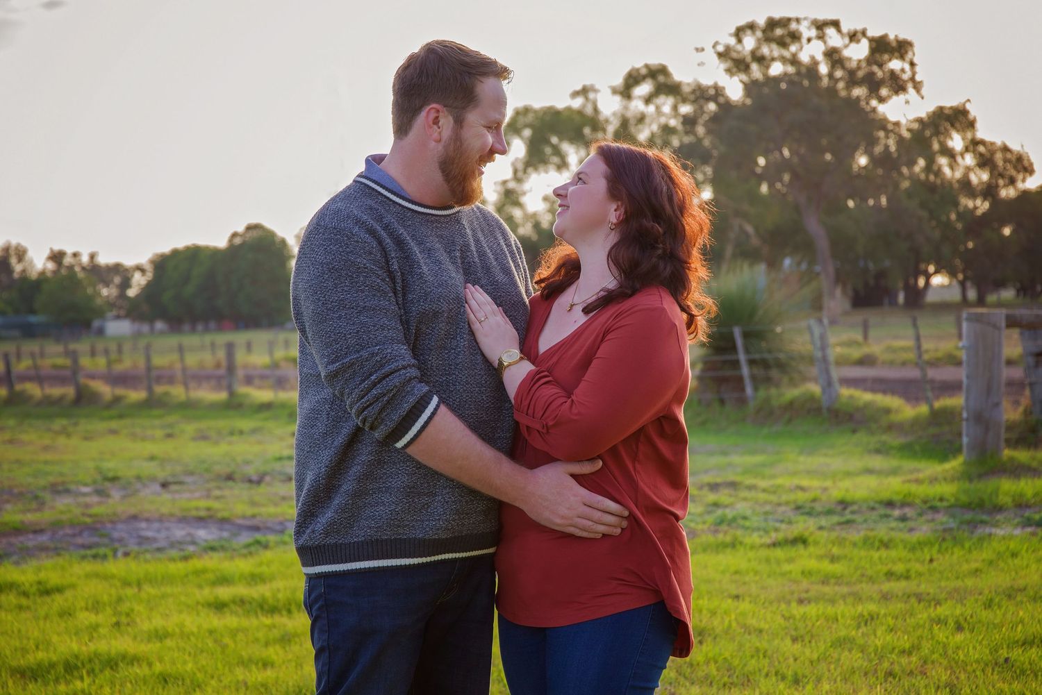 couple embracing on farm looking at each other