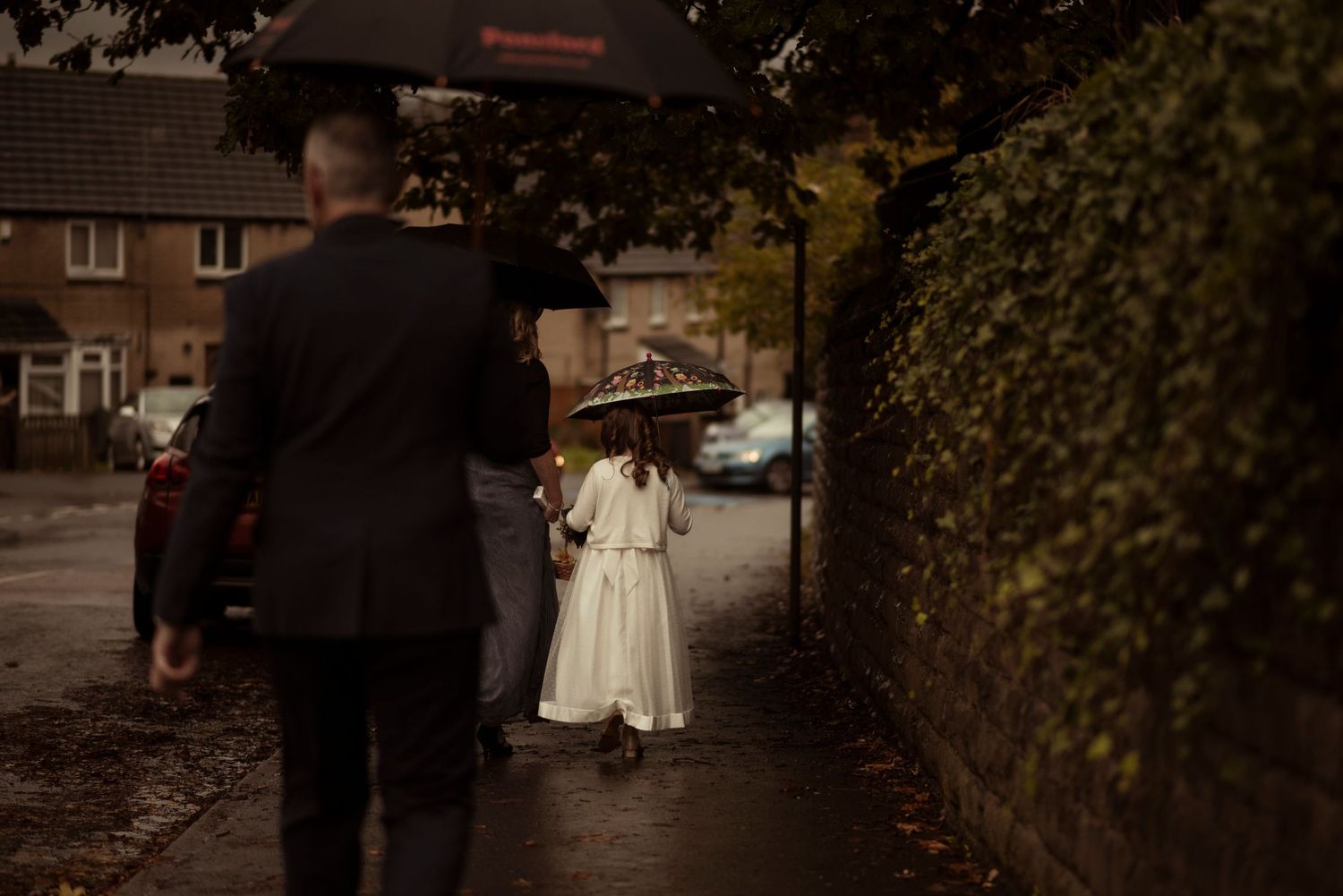 flower girl leaving church under a umbrella, sheffield wedding