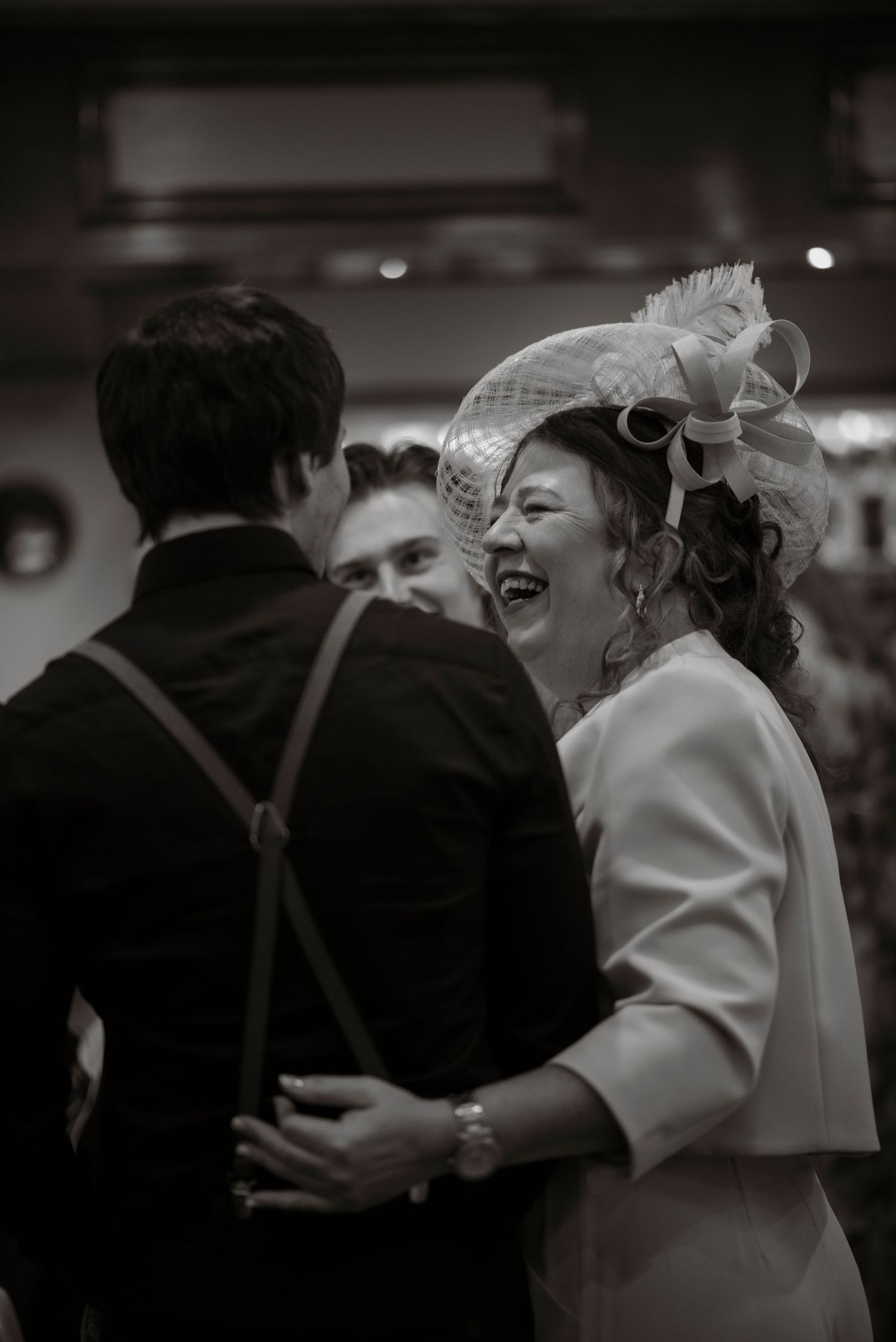 mother of the bride happily greeting guests