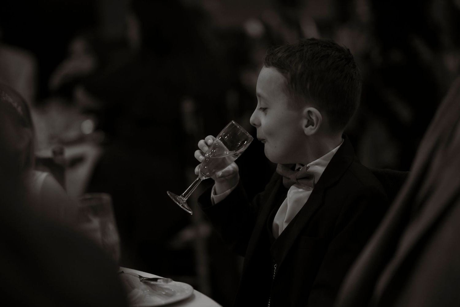 pageboy drinking from a champagne flute
