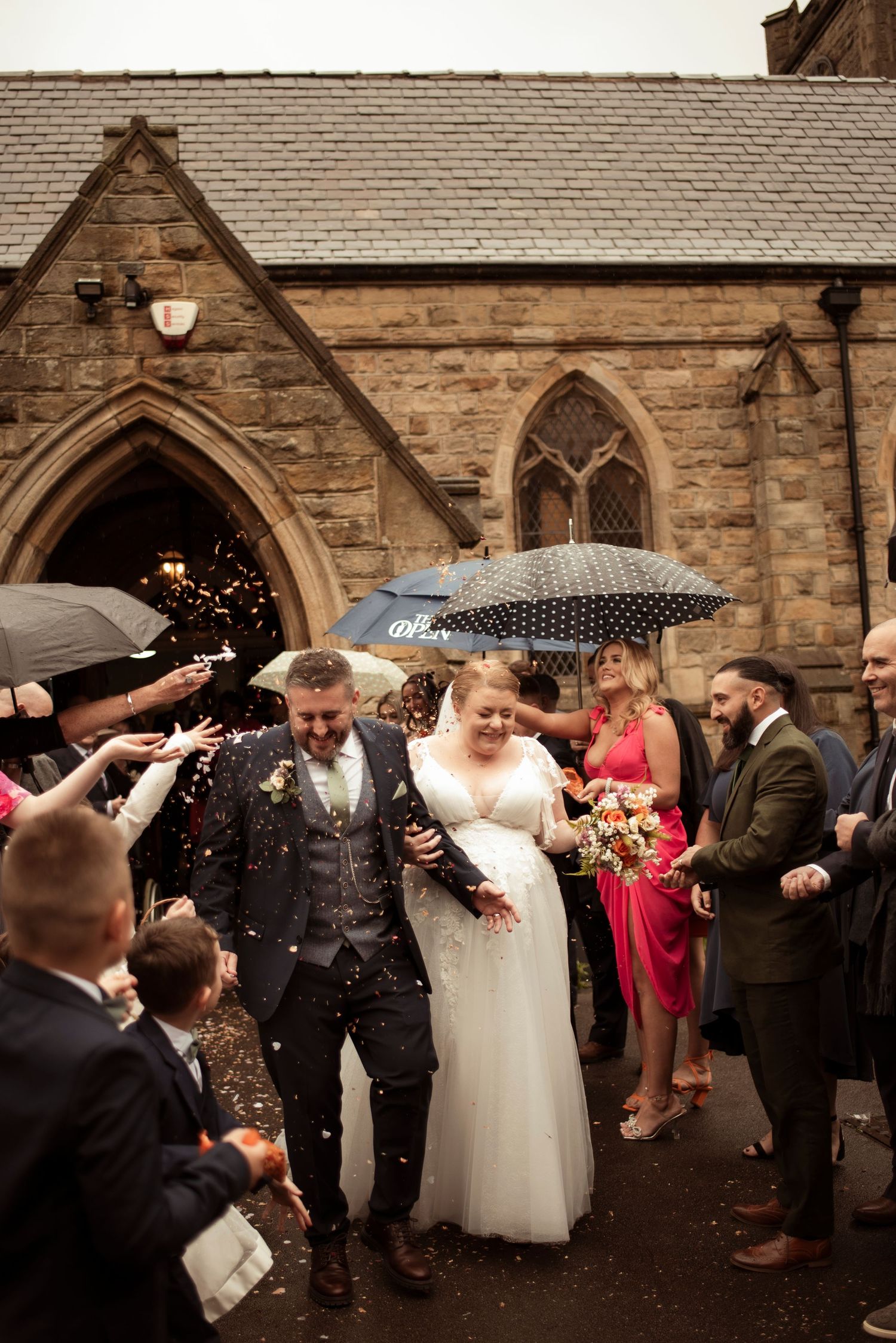bride and groom exiting the church, confetti