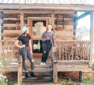Casual portraits taken on a rustic wooden porch of a log cabin.