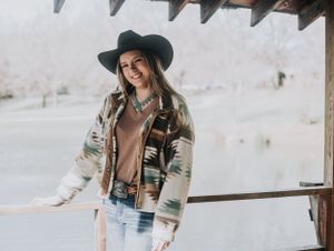 Western style outdoor photoshoot setup with natural lighting and rustic backdrop.