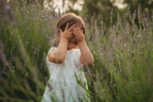 A dreamy scene in a lavender field with a white dress on a summer day.