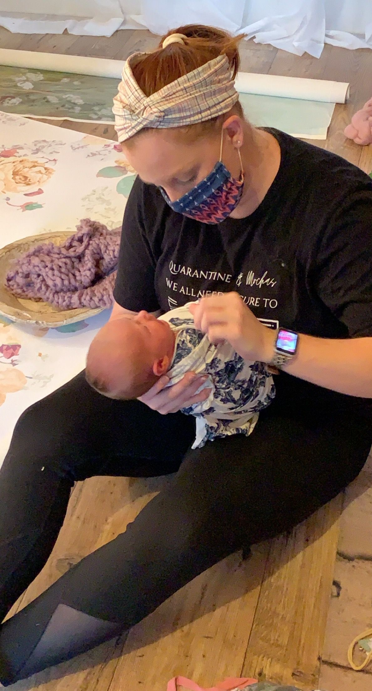 newborn photography wrapping and posing, photographer wearing mask