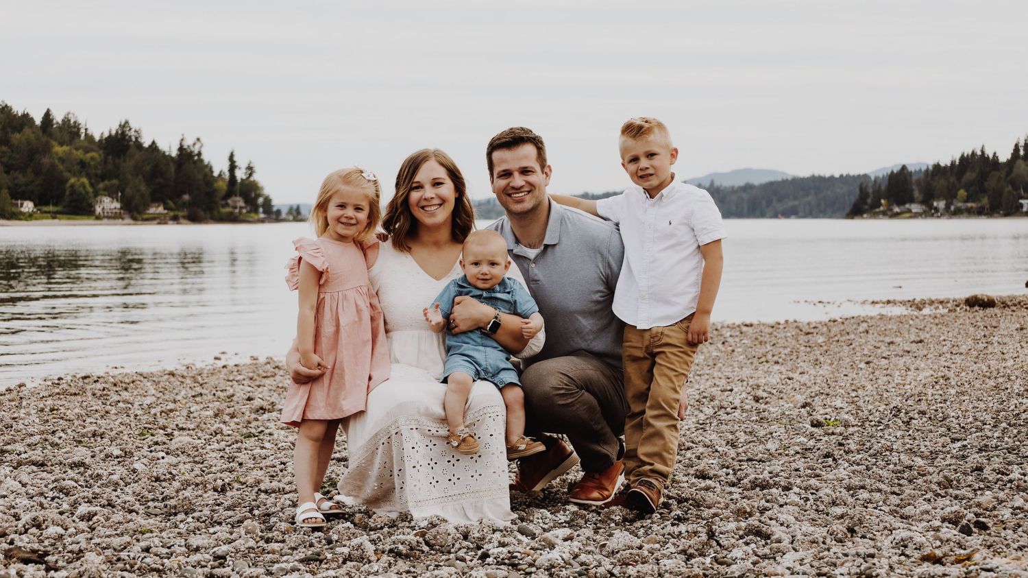 A warm and candid portrait of a couple/family, captured in natural light, with a timeless background.