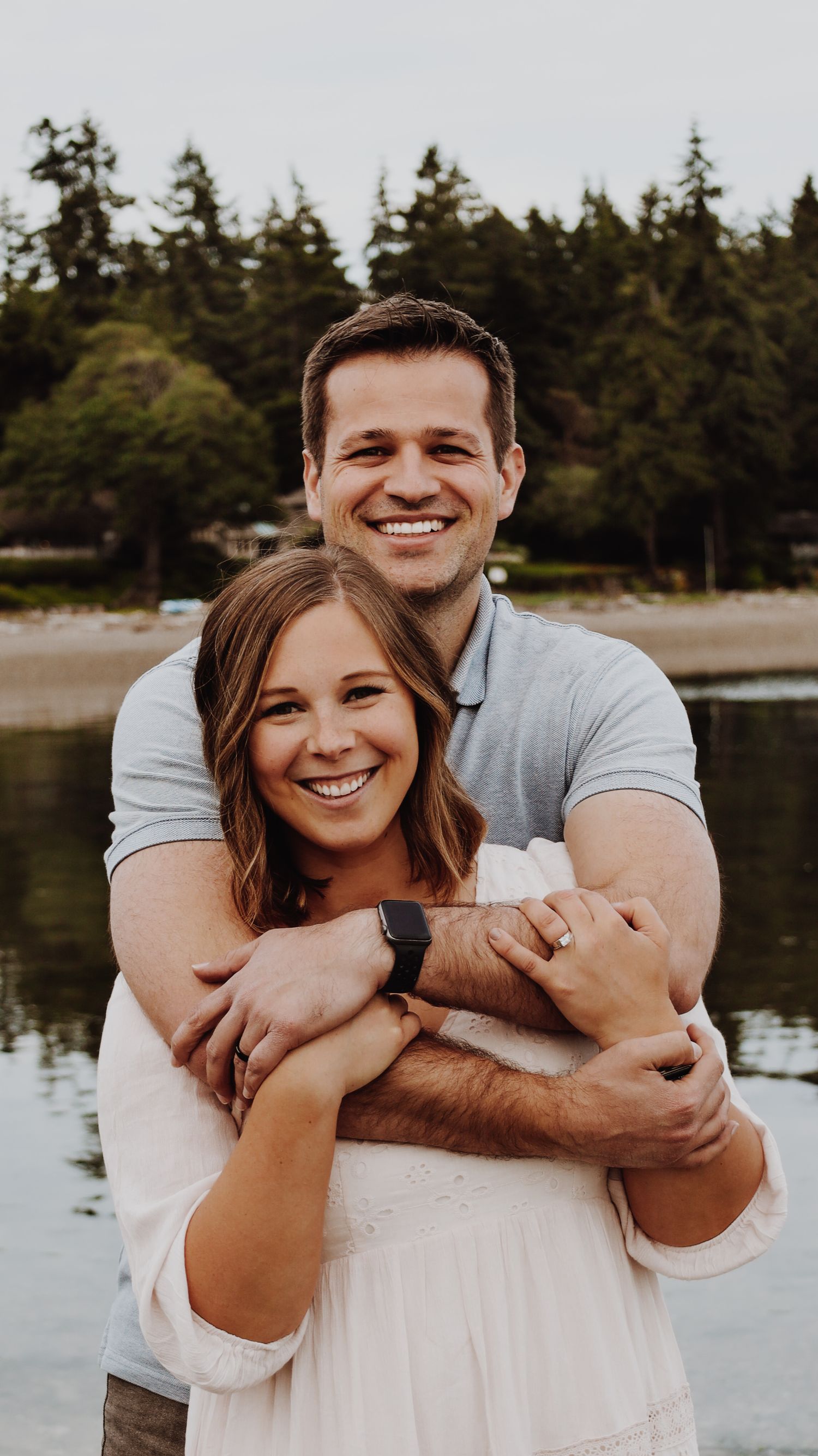 A warm and candid portrait of a couple/family, captured in natural light, with a timeless background.