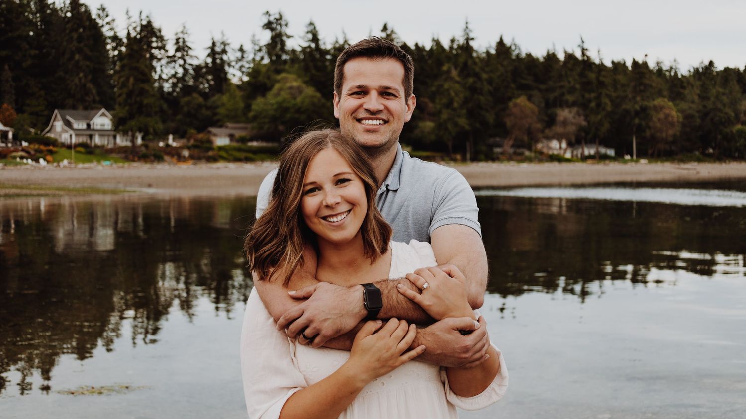 A warm and candid portrait of a couple/family, captured in natural light, with a timeless background.