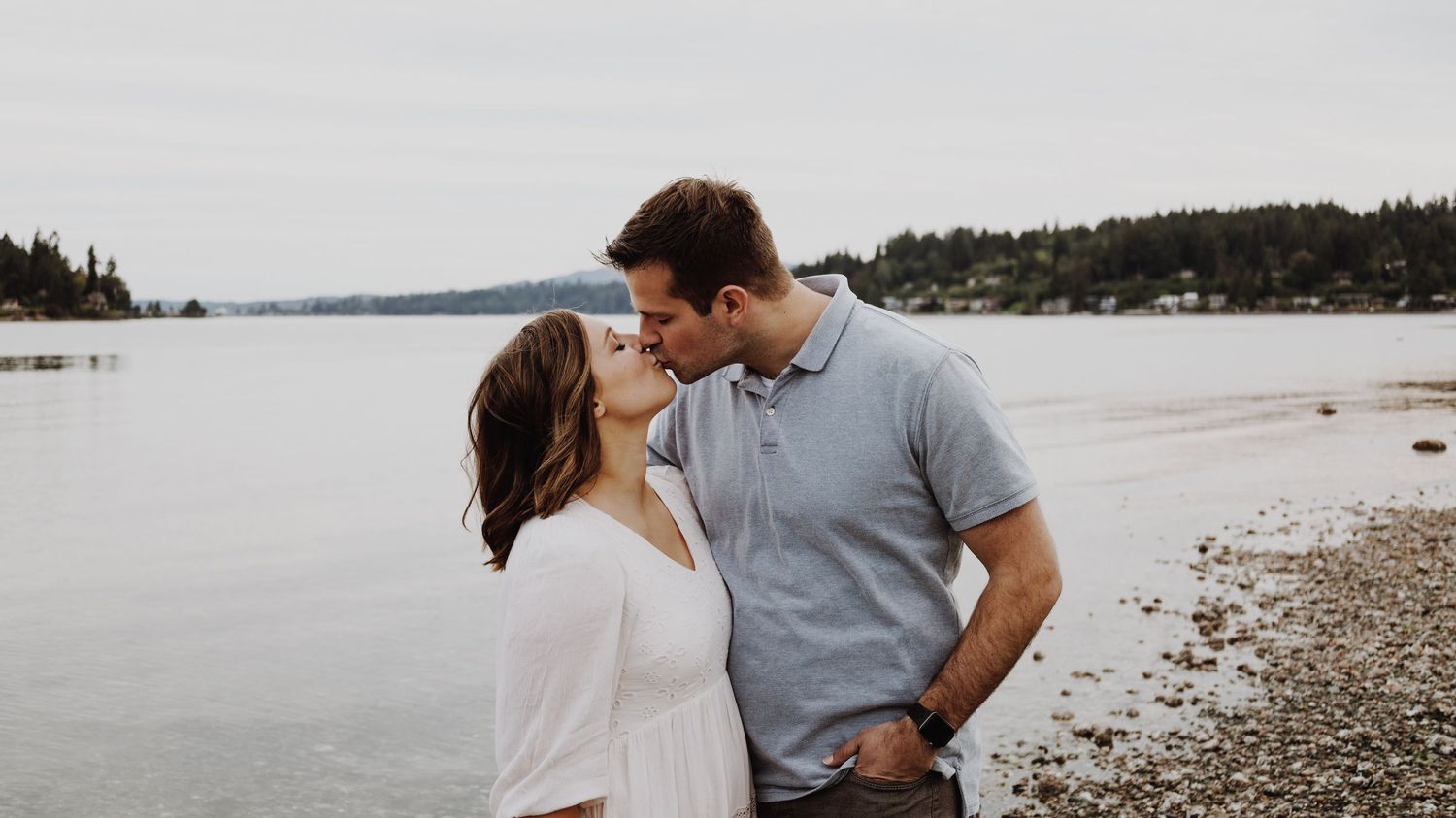 A warm and candid portrait of a couple/family, captured in natural light, with a timeless background.