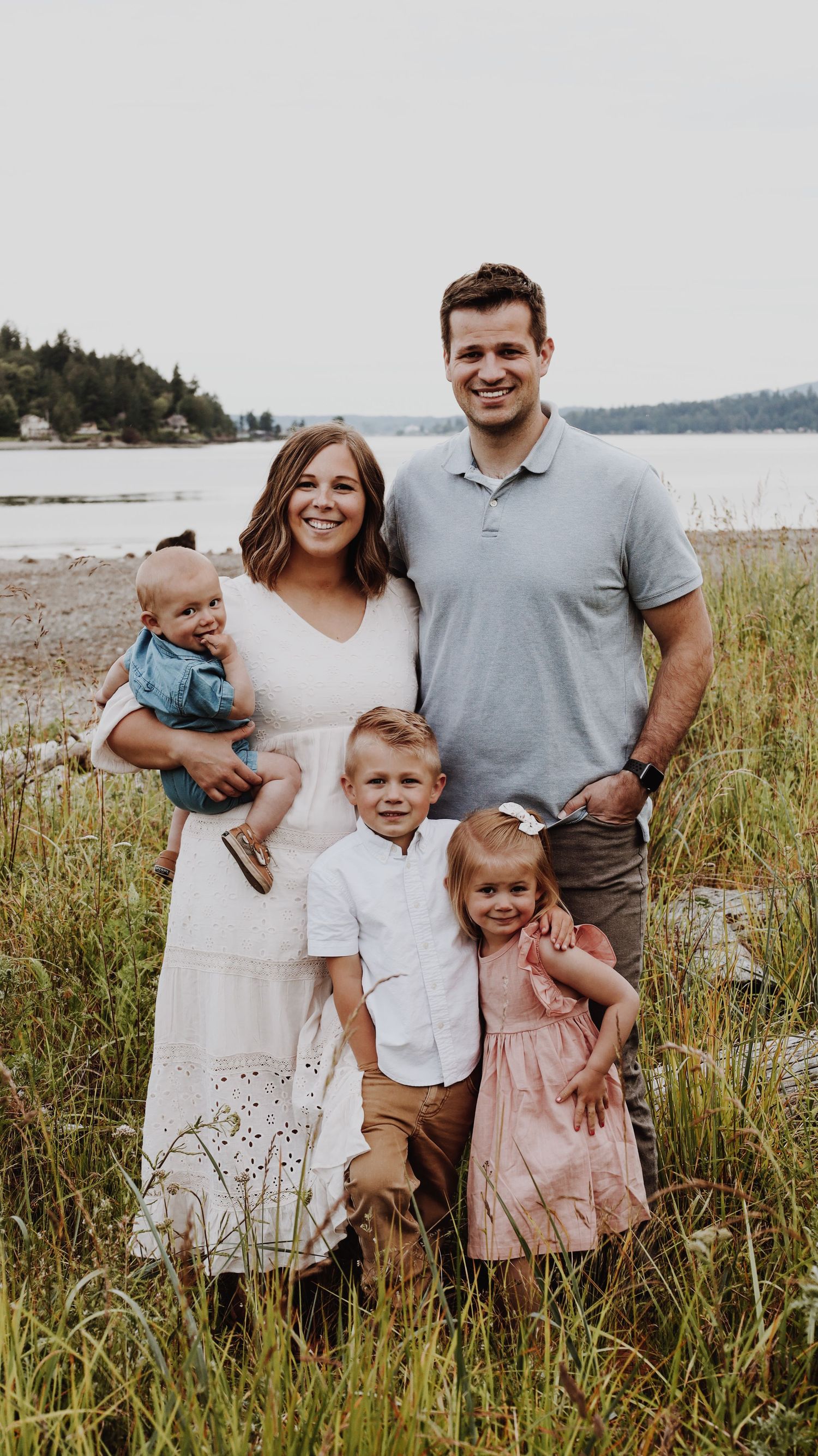 A warm and candid portrait of a couple/family, captured in natural light, with a timeless background.