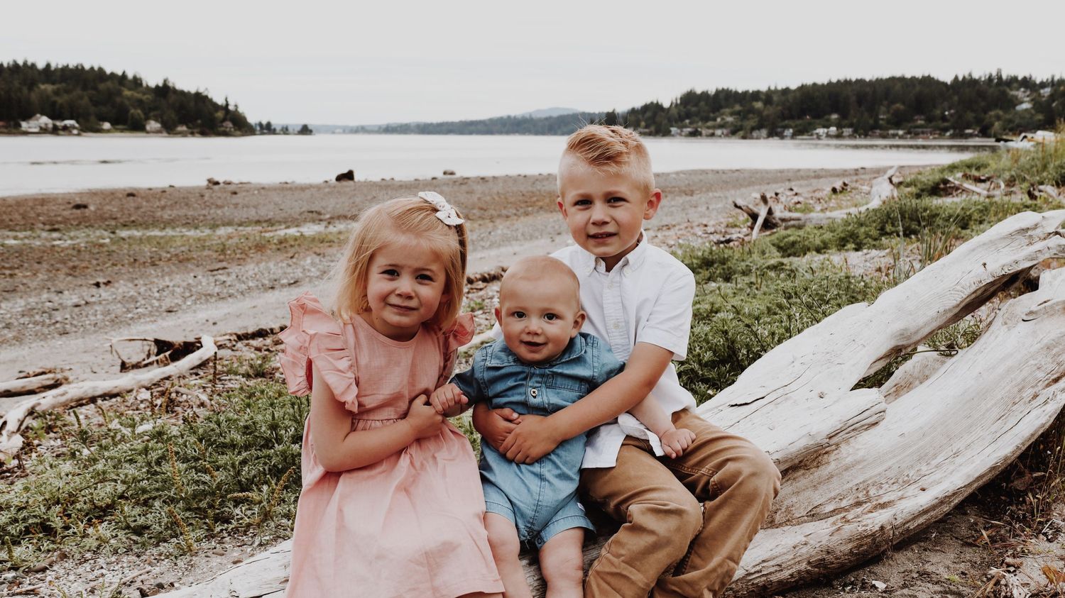 A warm and candid portrait of a couple/family, captured in natural light, with a timeless background.