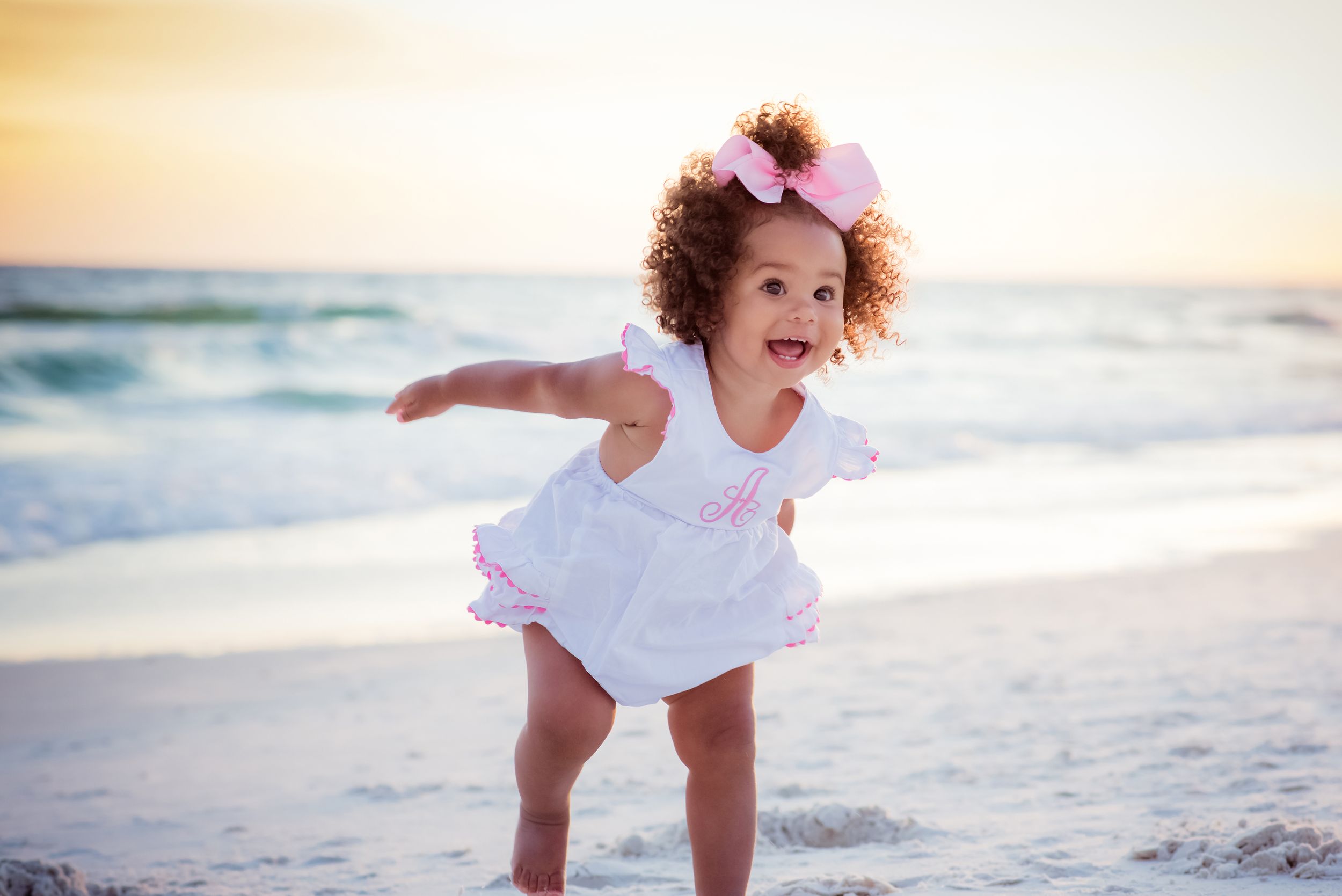 cute baby playing on the beach at sunset on Panama City Beach Florida