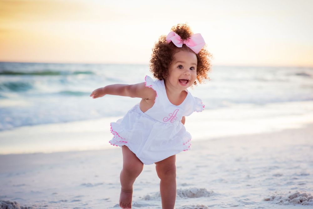 cute baby playing on the beach at sunset on Panama City Beach Florida