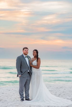 couple posing on the beach on their wedding day at sunset on Panama City Beach Florida