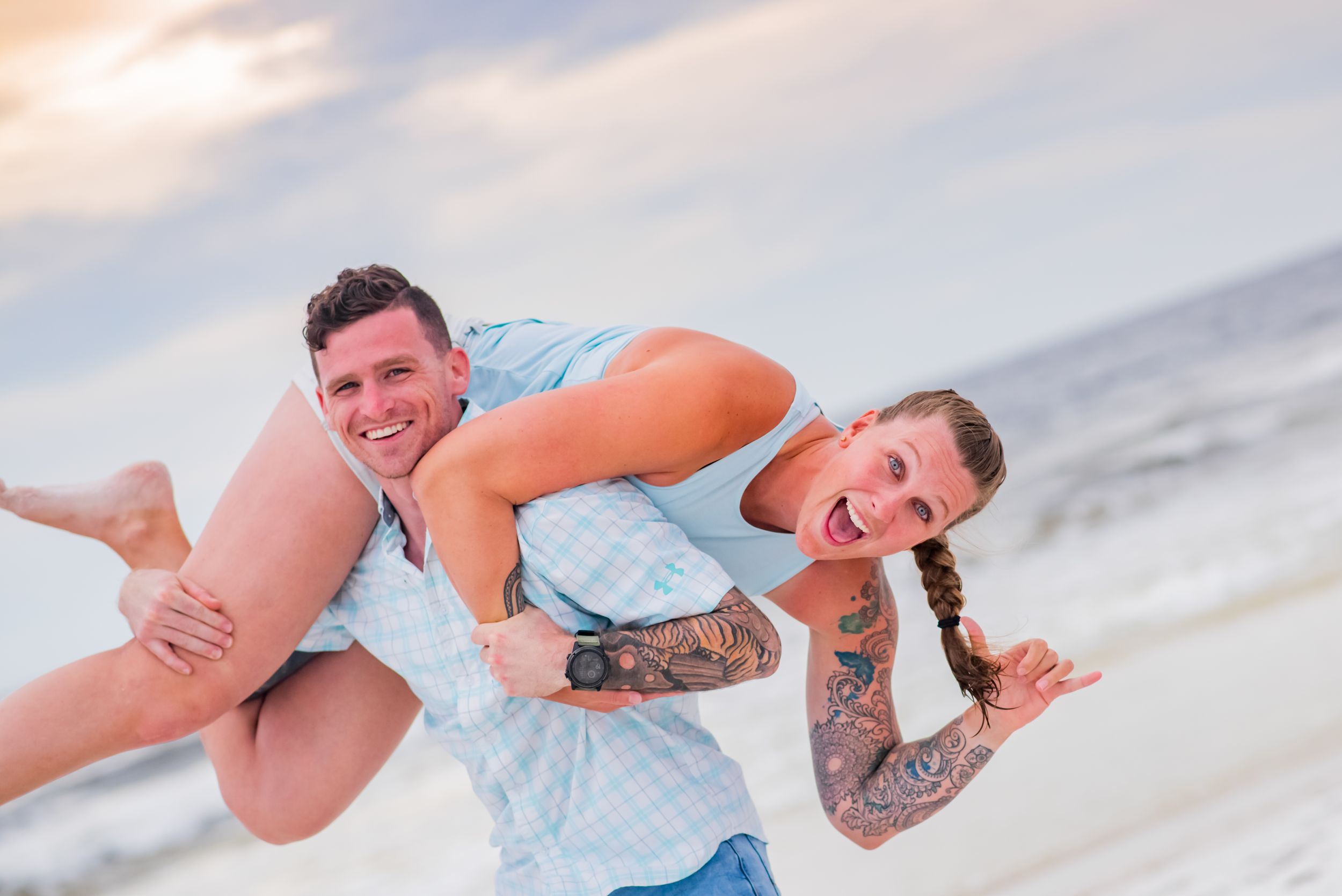 husband picking up his wife in fun picture on Panama City Beach Florida
