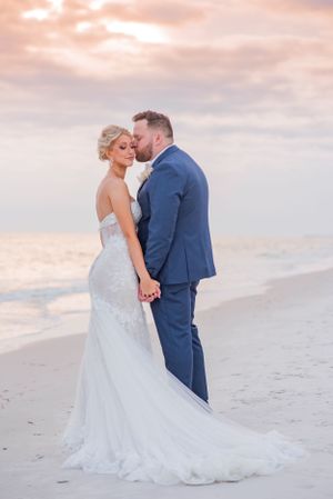 couple holding hands on their wedding day at sunset on Panama City Beach Florida